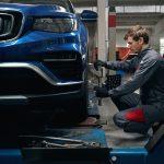 Image of a mechanic setting up a car for an alignment service