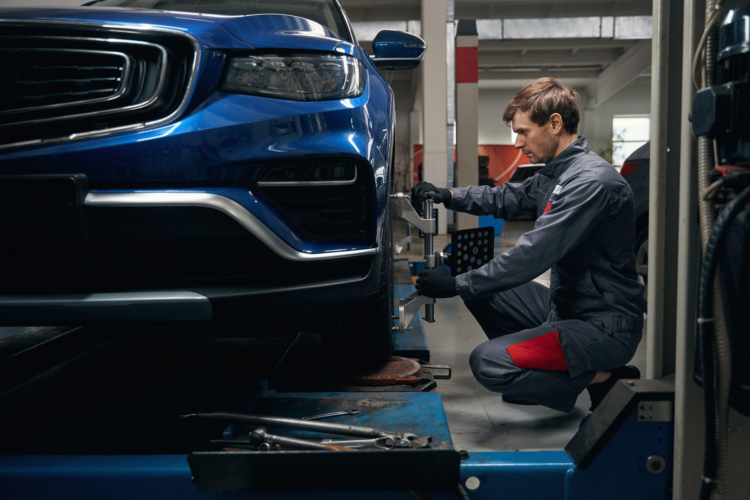 Image of a mechanic setting up a car for an alignment service