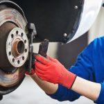 Image of a mechanic installing rear pads on a vehicle