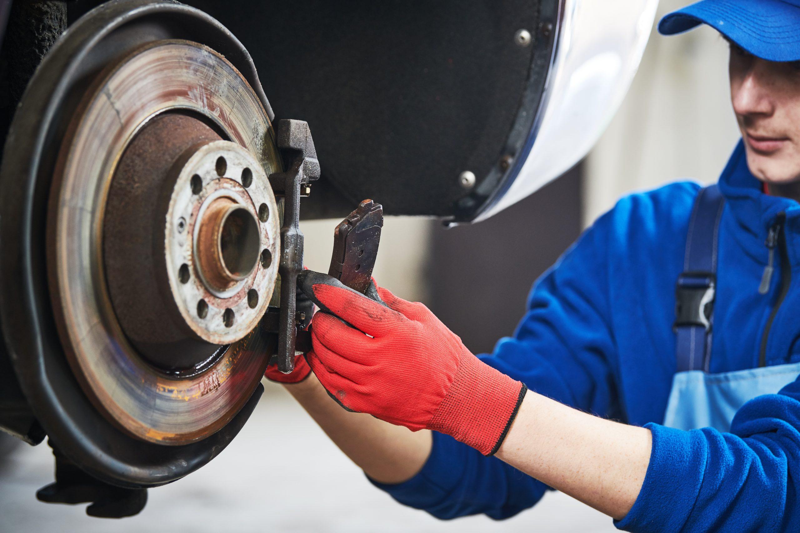 Image of a mechanic installing rear pads on a vehicle