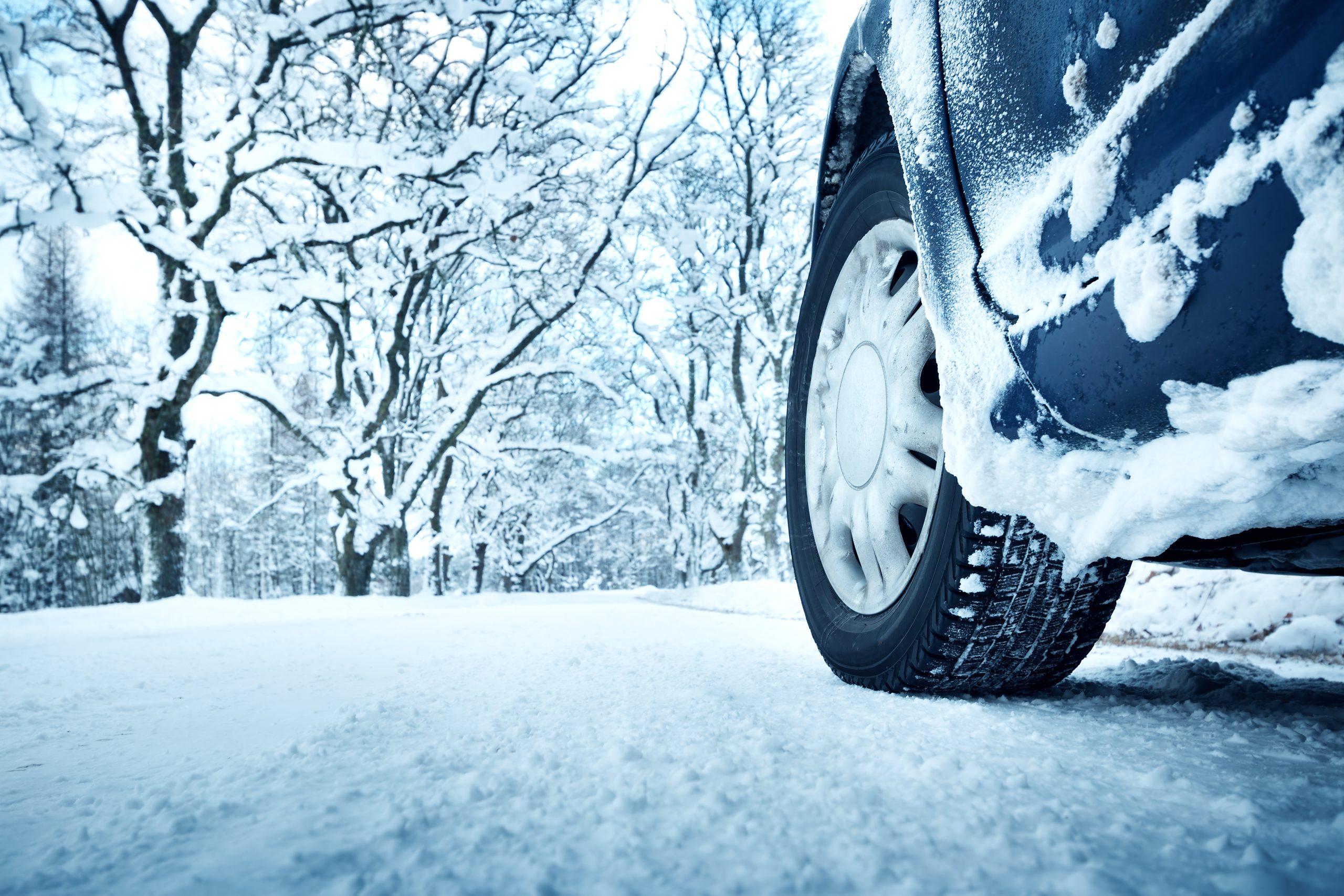 Image of a close up to the front driver tire in the snow