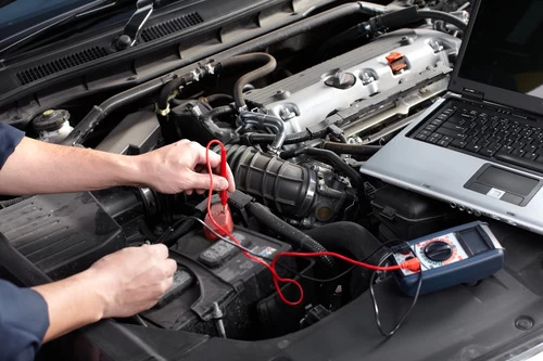 Image of mechanic hands on an engine performing a diagnosis