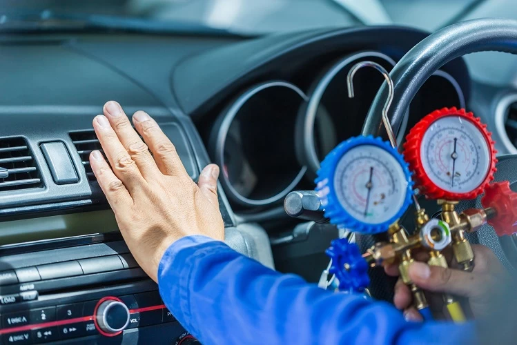 Image of mechanic hand on the air vent to make sure the cars a/c is working properly