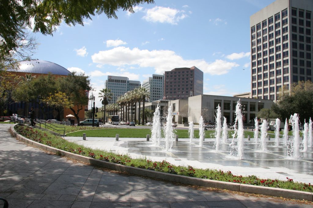 Image of fountain valley city, picture with fountain water and buildings in the back.