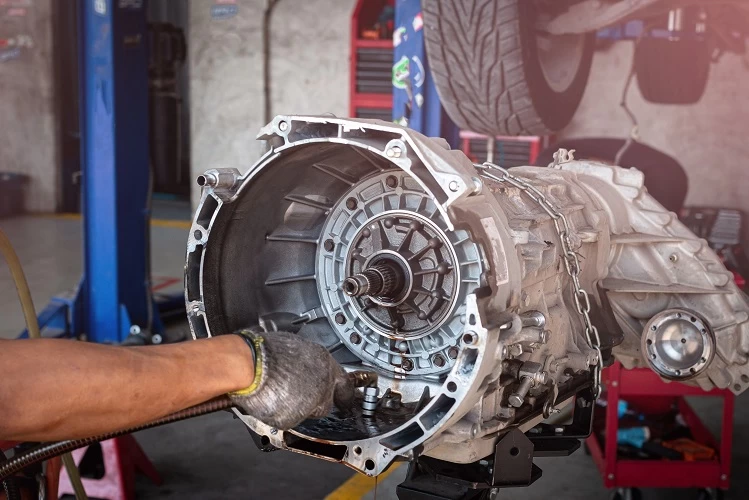 image of a mechanic inspecting a transmission